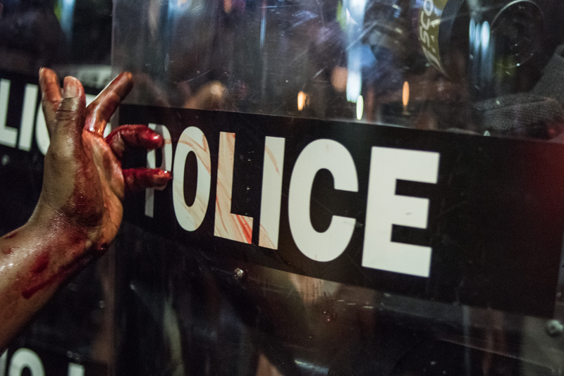 A woman smears blood on a police riot shield Sept. 21, 2016, in downtown Charlotte, N.C.Sean Rayford/Getty Images